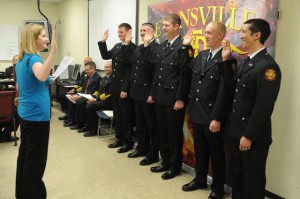 New firefighters taking their oath of office following their entry-level training.